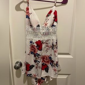 White Romper with floral design.